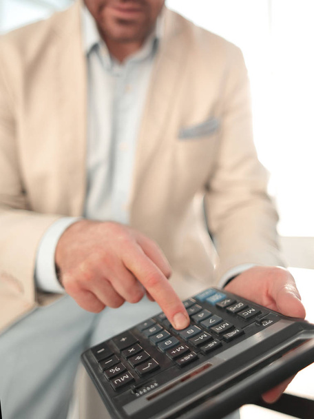 close up. businessman with calculator. - Fotografie, Obrázek