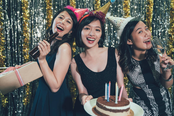 three young ladies holding cake and gift boxes - Valokuva, kuva