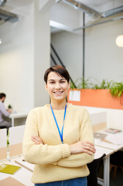 Young casual office worker with toothy smile and crossed arms standing in front of camera - Photo, Image