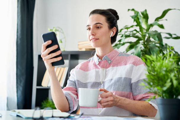 Woman Using Smartphone during Coffee Break - Photo, image