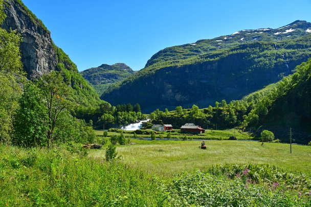 countryside farm with waterfall at flam Norway - Foto, afbeelding