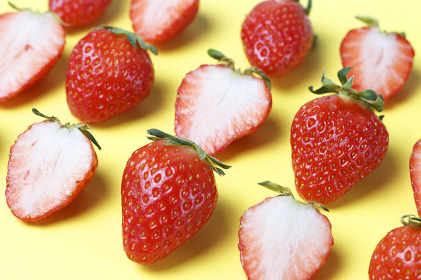 Pattern of strawberries isolated on yellow background, creative background - Photo, image