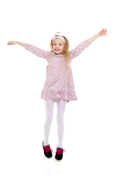 The little girl is jumping fun. - Фото, изображение