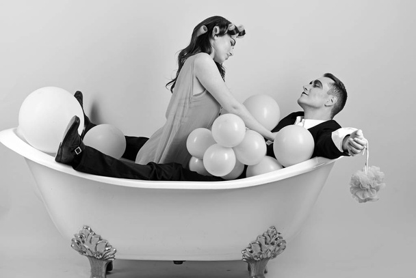Important part of life. Bubble bath day. Beauty routine and personal hygiene. Hair grooming routine. Bathing hygiene habit. Couple in love in bath tub. Couple of mime man and sexy woman enjoy bathing - Фото, зображення