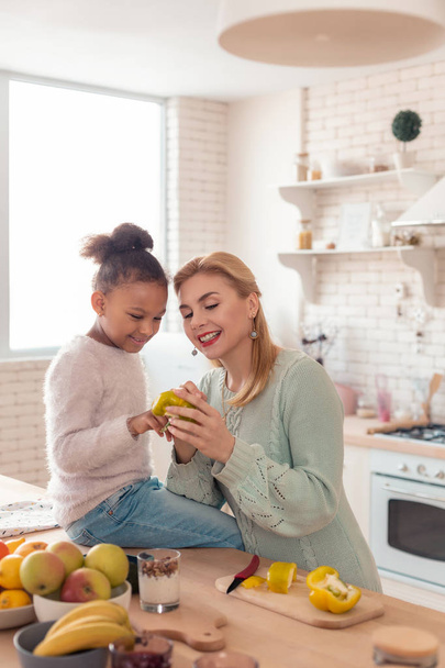 Mother and daughter feeling involved in cooking dinner - Photo, image