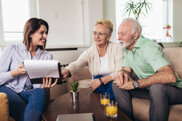 Positive aged couple consulting with insurance agent - Photo, Image