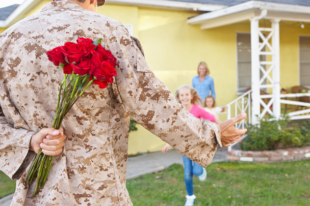 Family Welcoming Husband Home On Army Leave - 写真・画像