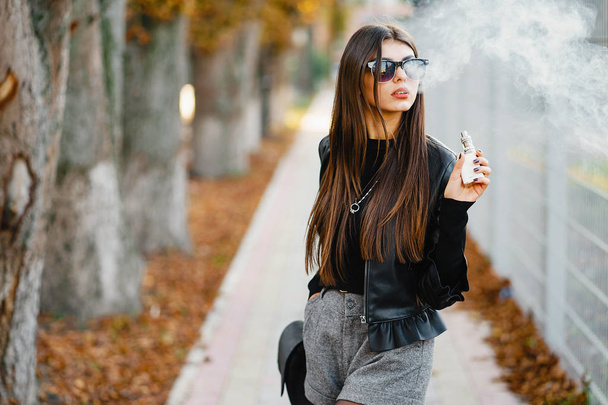 stylish girl smoking an e-cigarette - Photo, Image
