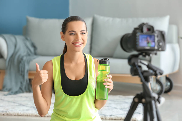Young female blogger recording sports video at home - Photo, image