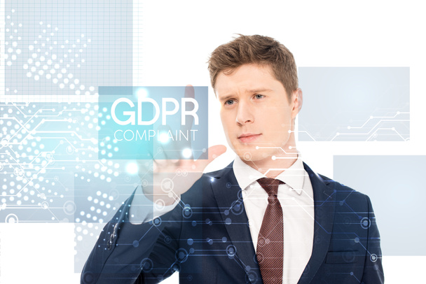 successful businessman in suit pointing with finger at gdpr compliant illustration on white background - Zdjęcie, obraz