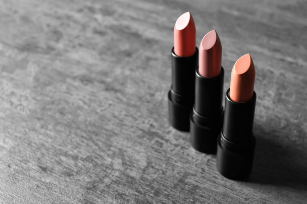 Different lipsticks on grey background - Photo, Image