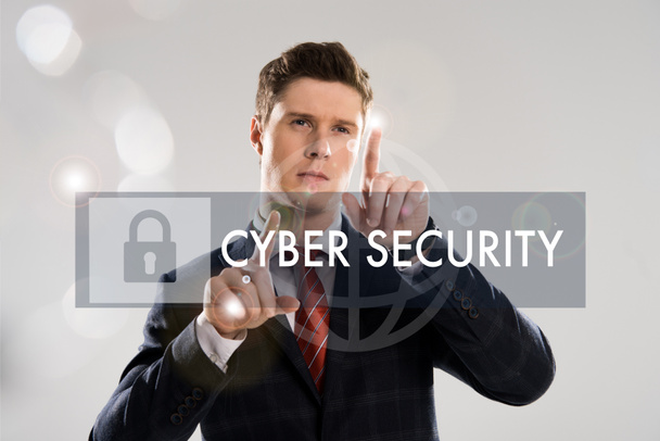 confident businessman in suit pointing with fingers at cyber security illustration in front  - Photo, Image