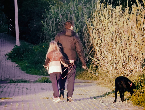 Dad and daughter walking the dog - Foto, immagini