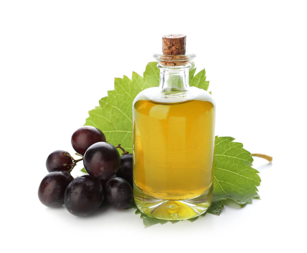 Bottle with grape seed oil on white background - Foto, imagen