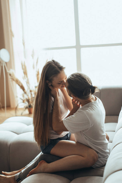 Close-up of young romantic couple is kissing and enjoying the company of each other at home - Photo, image
