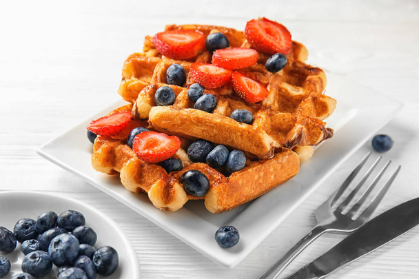 Delicious waffles with berries on plate - Photo, Image