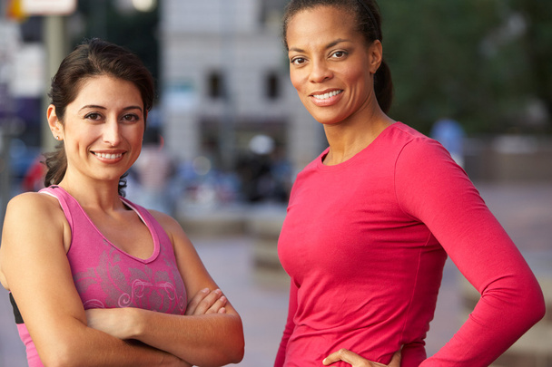 Portrait Of Two Female Runners On Urban Street - 写真・画像