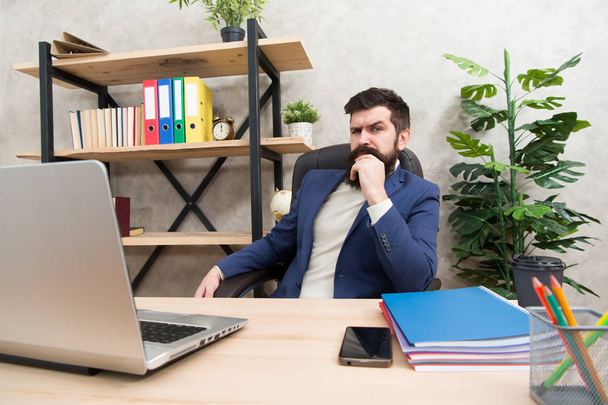 Developing business strategy. Risky business. Concentration and focus. Man bearded boss sit office with laptop. Manager solving business problems. Businessman in charge of business solutions - Foto, Imagen