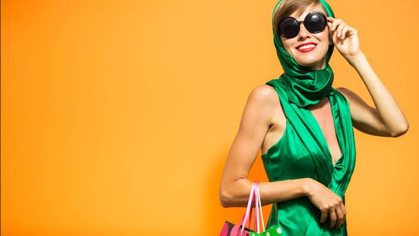 Beautiful woman with shopping bags. Spring or summer shopping concept - 写真・画像