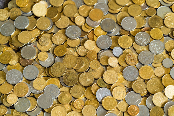 Golden coins texture. Ukrainian hryvnia. Abstract background. - Fotó, kép