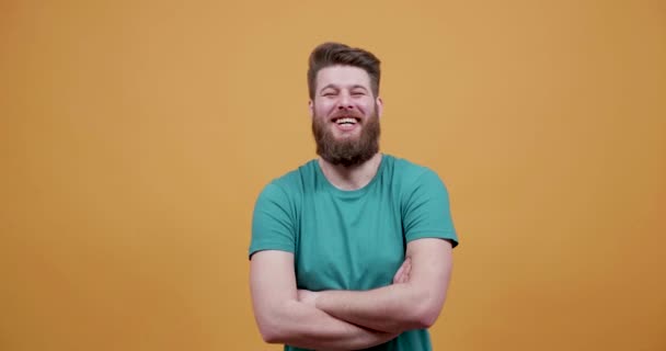 Portrait of a young hipster with big beard laughing very loud - Felvétel, videó