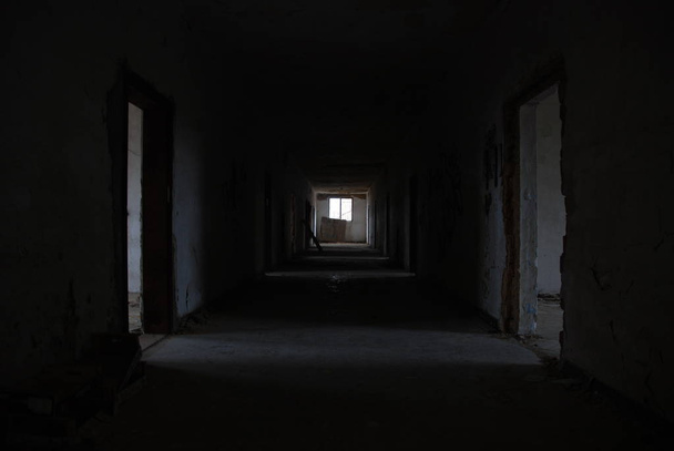 Dark corridor of abandoned decay building with few light, urbex  - Foto, immagini