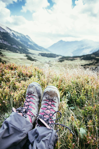 Alpine boots in foreground, idyllic mountain landscape in the bl - Valokuva, kuva
