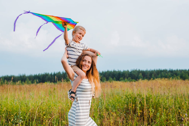 Mom and son play actively and have fun outdoors. - Photo, Image
