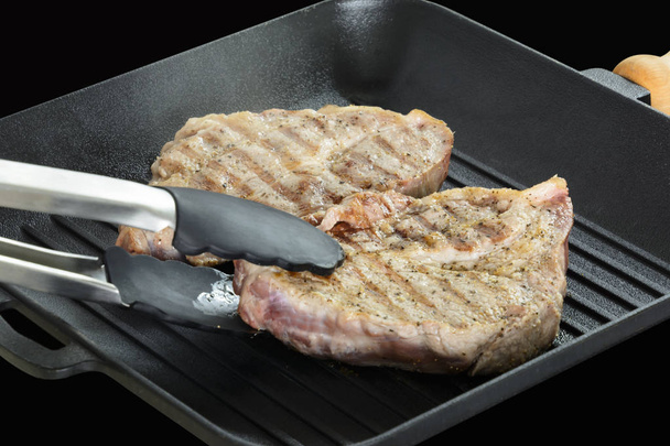 Cooking process of Grilled beef steaks on grill pan. - Photo, Image