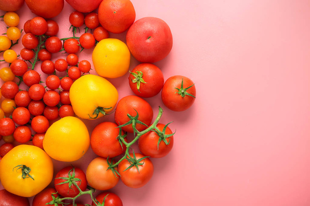 Composition with different types of tomatoes on color background - Photo, Image
