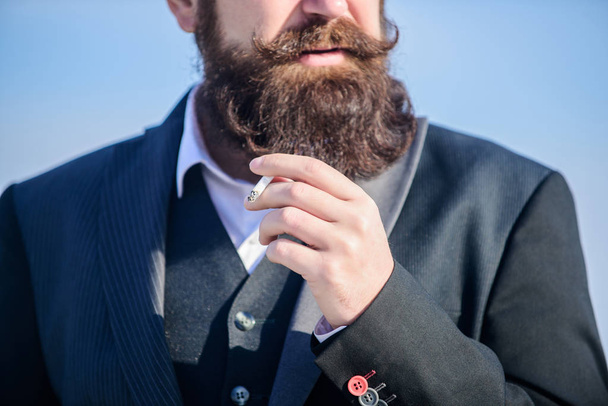 Stop smoking. Bearded man smoking cigarette. smoke. brutal caucasian hipster with moustache. Future success. Male formal fashion. Businessman against the sky. Mature hipster with beard - Фото, изображение