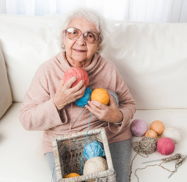 Grandmother holding knitting laces balls - Photo, image