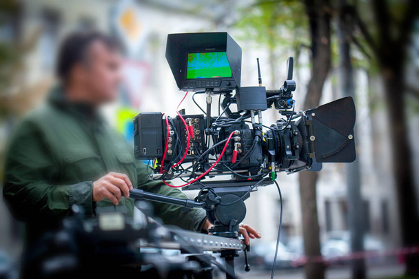 Blurry image of movie shooting or video production and film crew team with camera equipment at outdoor location - 写真・画像