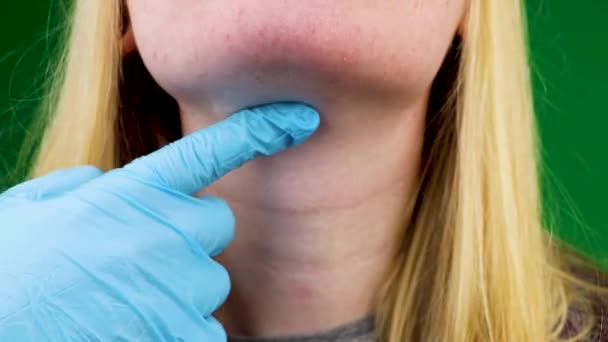 Palpation of the thyroid gland and throat. Examination by a doctor. Black background - Video