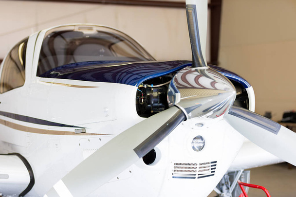 Невеликий приватний гвинтовий літак в ангарі
 - Фото, зображення