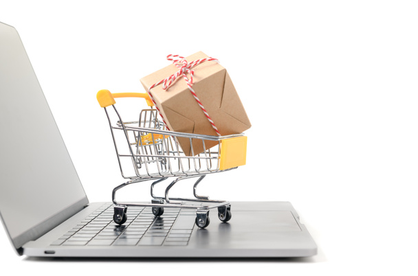Boxes in a trolley on a laptop keyboard isolated  - 写真・画像