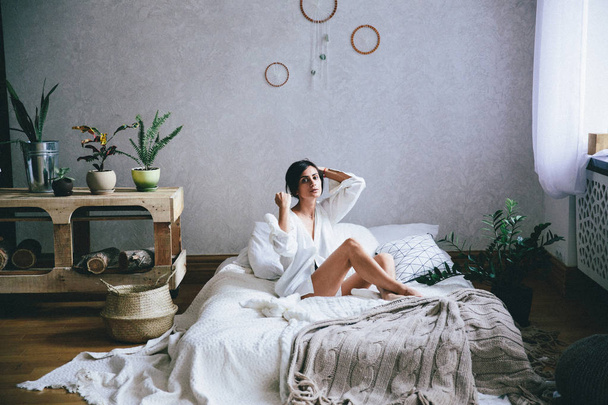 young woman resting on bed at home - Fotoğraf, Görsel