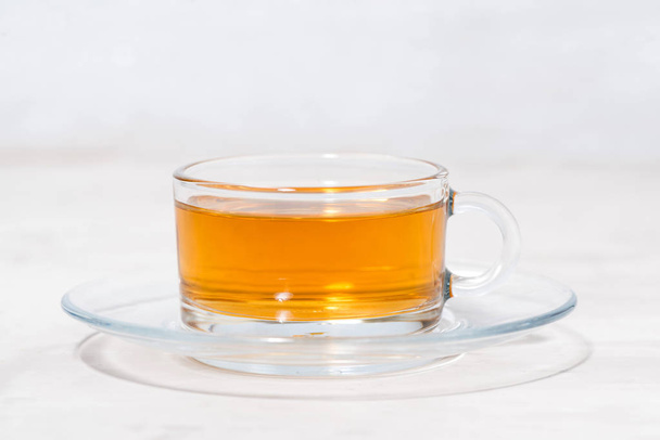 tea in a glass cup on a white background - Zdjęcie, obraz