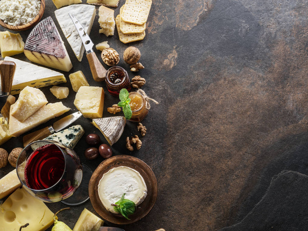 Cheese platter with organic cheeses, fruits, nuts and wine on st - Photo, Image