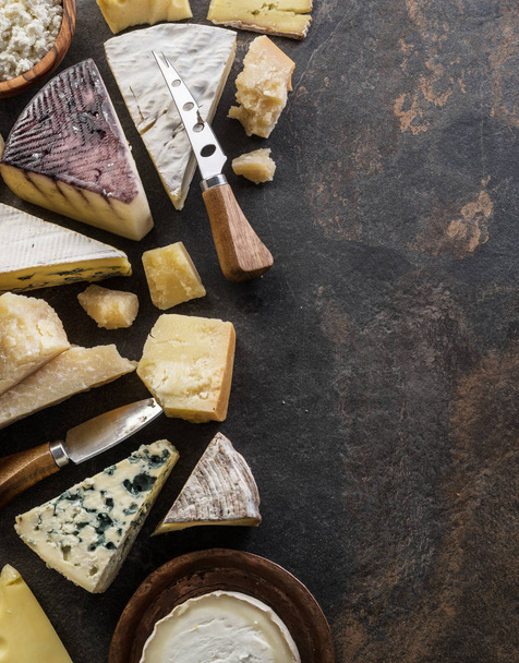 Assortment of organic cheeses on stone background. Top view. Tas - Photo, Image