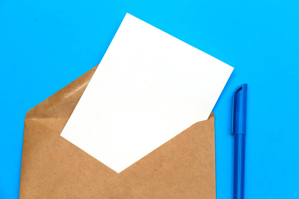 Postal envelope with a letter on a blue background. copy-paste - Photo, Image
