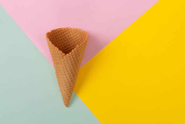 Ice cream cone on pastel colorful background. Minimal summer concept. Flat lay. - Photo, Image