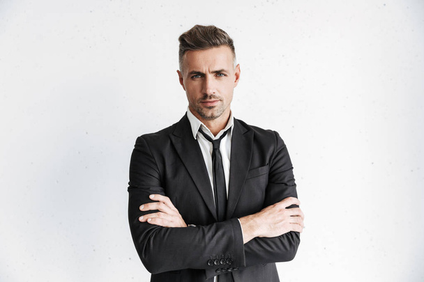 Handsome business man posing isolated over white wall background. - Fotó, kép