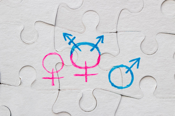transgender symbol, female and male gender symbol drawn on the puzzle concept of equality - Foto, imagen