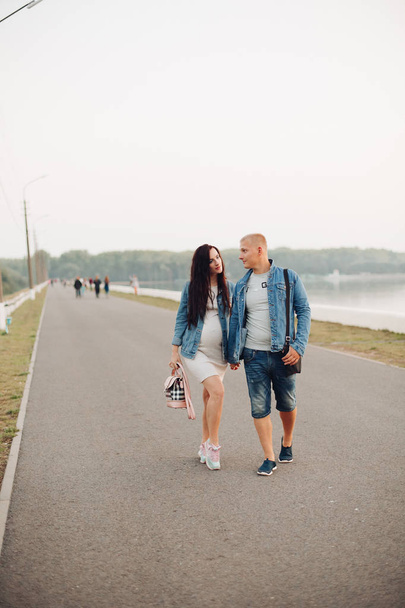 Future parent walking together in fresh air and laughing - Zdjęcie, obraz