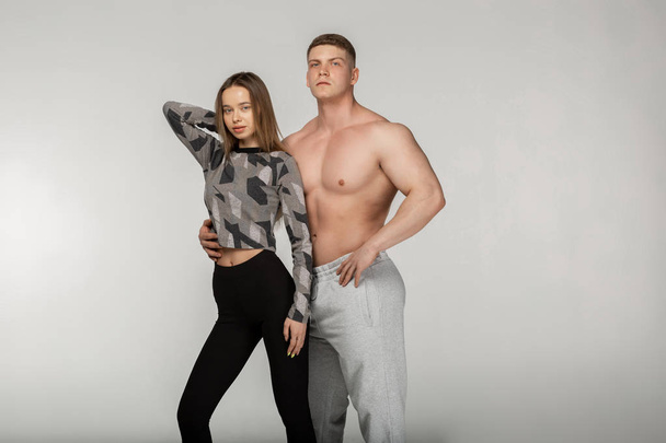 Sport, fitness, workout concept. Fit couple, strong muscular shirtless man and slim woman - Φωτογραφία, εικόνα