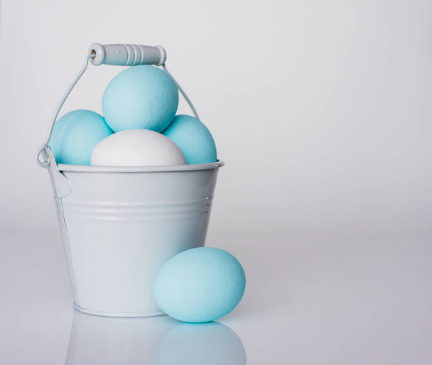 Spring and Easter holiday concept. Easter eggs painted blue and white, pastel color background. Isolated on white. - Photo, Image
