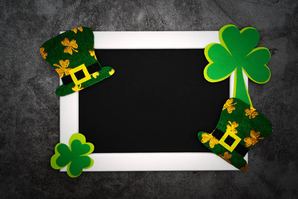 St Patricks day, festive leprechaun hat and green Shamrocks on the photo frame - Photo, Image