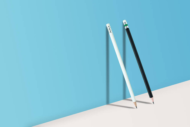 Business Creative and Idea Concept : Black and White pencils standing on white floor and shadow on blue wall. - Fotó, kép
