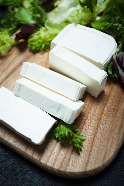 Natural feta cheese from cow's milk sliced with slices. - Fotoğraf, Görsel